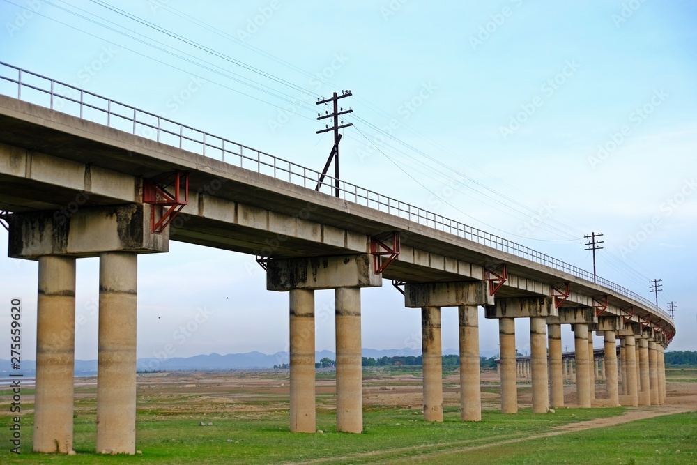 The railway across the reservoir at Pa Sak Jolasid Dam, Lop Buri, Thailand.