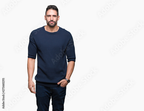 Young handsome man wearing sweater over isolated background Relaxed with serious expression on face. Simple and natural looking at the camera.
