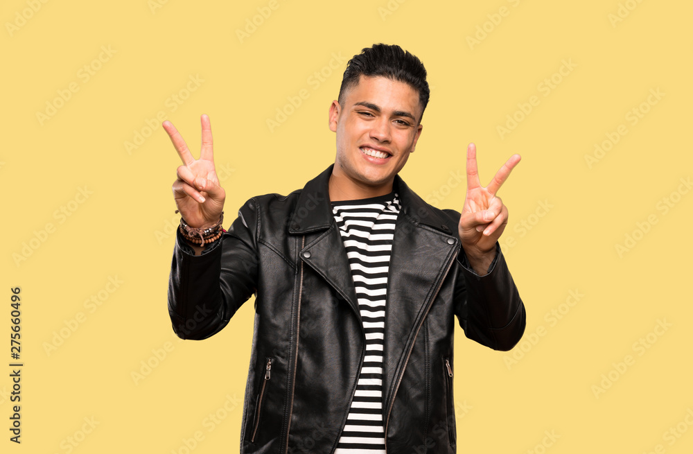 Young man showing victory sign with both hands over isolated background Young man showing victory sign with both hands over isolated background