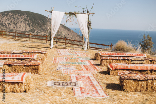 Arch decorated with lively floristics on the background of the sea. Boho style photo