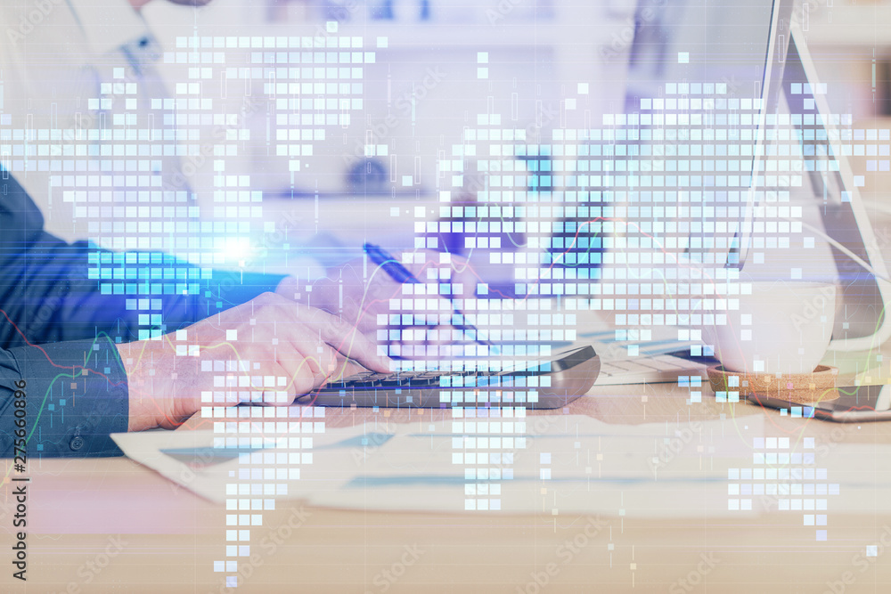 Fototapeta premium Double exposure of businessman working on laptop on background. International business hologram in front. Concept of success.