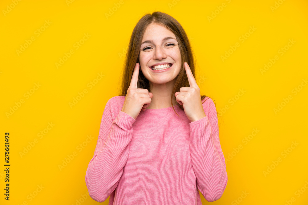 Young woman with long hair over isolated yellow wall smiling with a happy and pleasant expression Young woman with long hair over isolated yellow wall smiling with a happy and pleasant expression