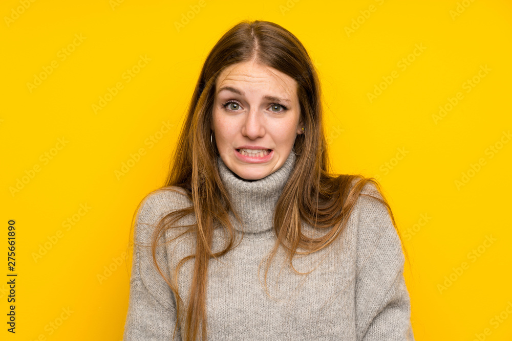 Young woman with long hair over yellow background having doubts and with confuse face expression Young woman with long hair over yellow background having doubts and with confuse face expression