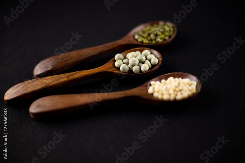 collection set of urad dal, beans, green peas, lentils, rice in wooden spoons.