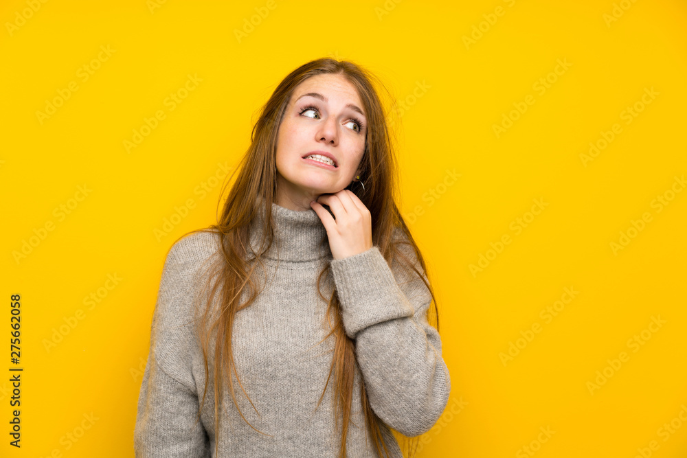 Young woman with long hair over yellow background standing and thinking an idea Young woman with long hair over yellow background standing and thinking an idea