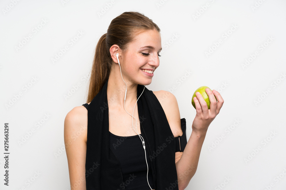 Young sport woman over isolated white background with an apple Young sport woman over isolated white background with an apple