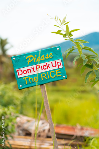 The announcing sign with the inscription around the rice fields. The concept of prevention and warning signs