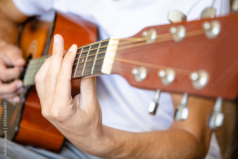 close up of an acoustic guitar player