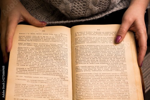 hand of a woman on old book