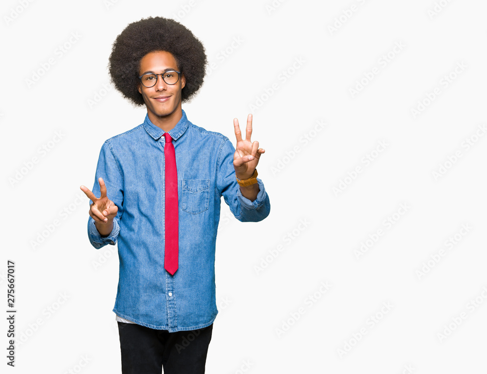 Young african american business man with afro hair wearing glasses and red tie smiling looking to the camera showing fingers doing victory sign. Number two. Young african american business man with afro hair wearing glasses and red tie smiling looking to the camera showing fingers doing victory sign. Number two.