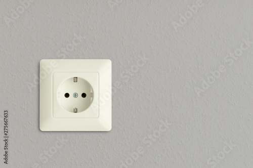 electrical power socket on gray wall, electric power outlet on grey background, european standard