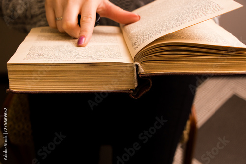 hand of a woman on old book