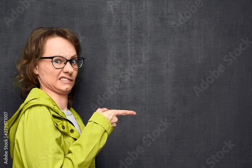 Fotografija Portrait of young woman pointing at something disgusting