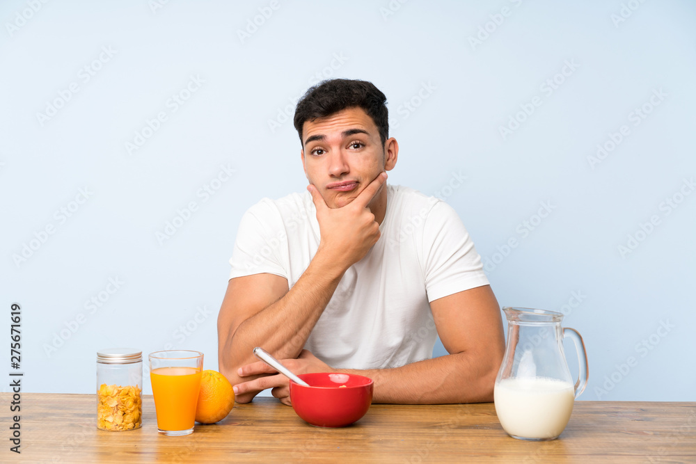 Handsome man in having breakfast thinking an idea Handsome man in having breakfast thinking an idea