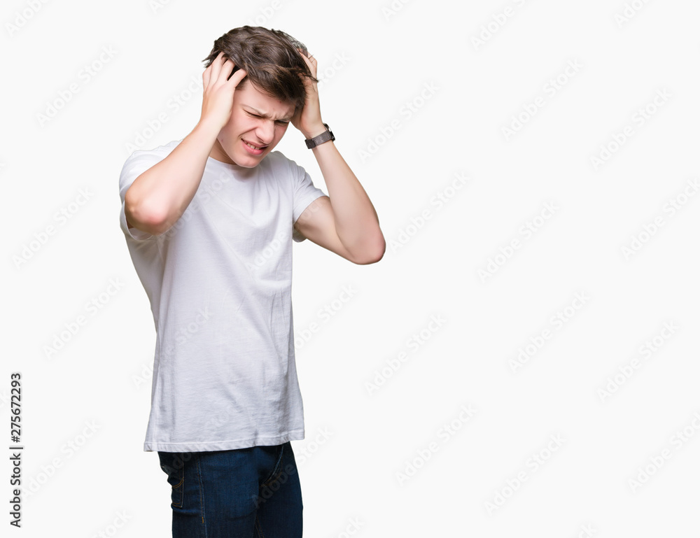 Young handsome man wearing casual white t-shirt over isolated background suffering from headache desperate and stressed because pain and migraine. Hands on head. Young handsome man wearing casual white t-shirt over isolated background suffering from headache desperate and stressed because pain and migraine. Hands on head.