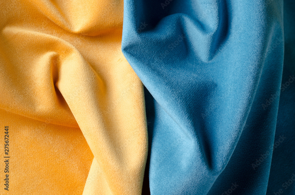 Yellow and blue soft velour fabric. Colors of ukrainian flag. Fabric texture background. Yellow and blue soft velour fabric. Colors of ukrainian flag. Fabric texture background.