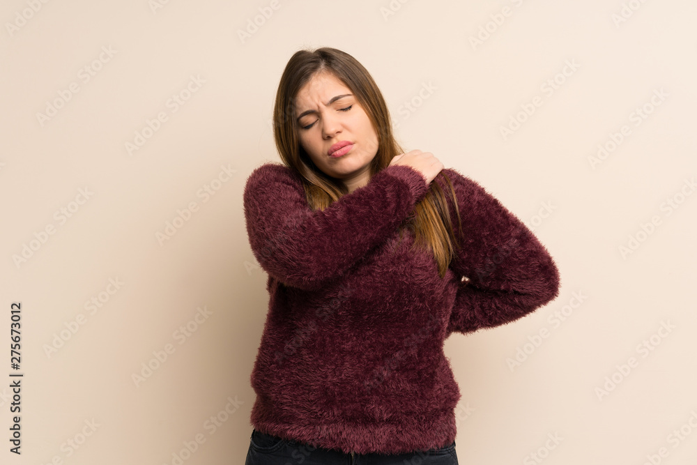 Young girl suffering from pain in shoulder for having made an effort Young girl suffering from pain in shoulder for having made an effort