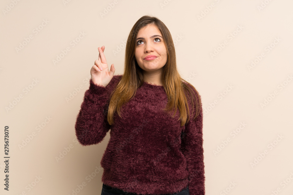 Young girl with fingers crossing and wishing the best Young girl with fingers crossing and wishing the best