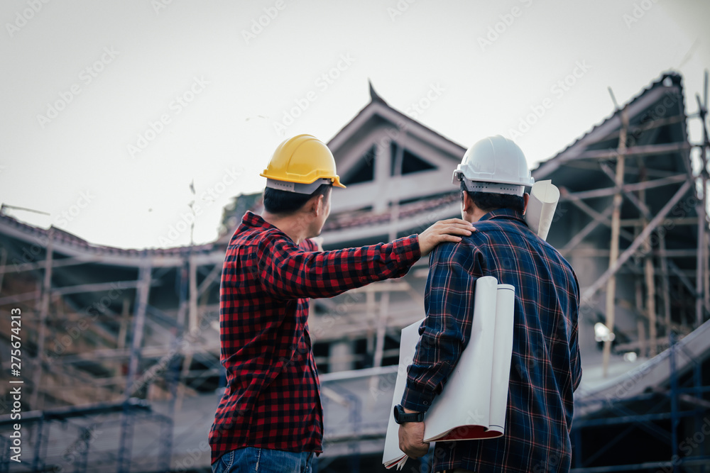 Fototapeta premium Engineers, construction sites, two businessmen Engineering objects in the workplace with architectural plans Draft construction project