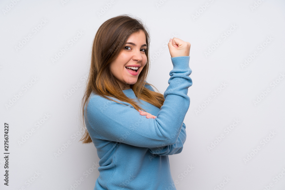 Young girl with blue sweater making strong gesture Young girl with blue sweater making strong gesture