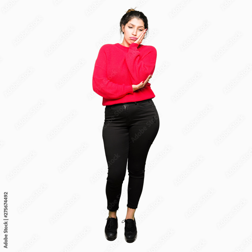Young beautiful woman wearing red sweater and bun thinking looking tired and bored with depression problems with crossed arms. Young beautiful woman wearing red sweater and bun thinking looking tired and bored with depression problems with crossed arms.