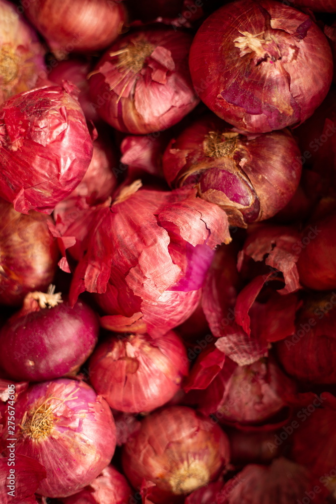 red onion pile in market . red onion pile in market .
