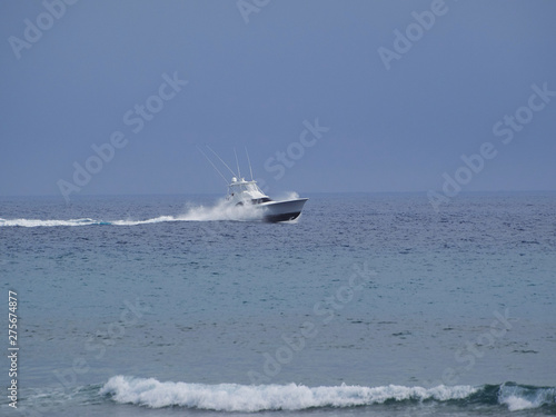 White yacht sailing at high speed in the Atlantic Ocean. © Andrei