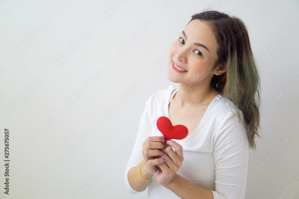 Asian woman holding a red heart in her hands. Asian woman holding a red heart in her hands.