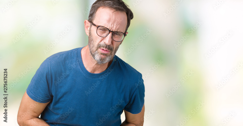 Handsome middle age hoary senior man wearin glasses over isolated background with hand on stomach because nausea, painful disease feeling unwell. Ache concept. Handsome middle age hoary senior man wearin glasses over isolated background with hand on stomach because nausea, painful disease feeling unwell. Ache concept.
