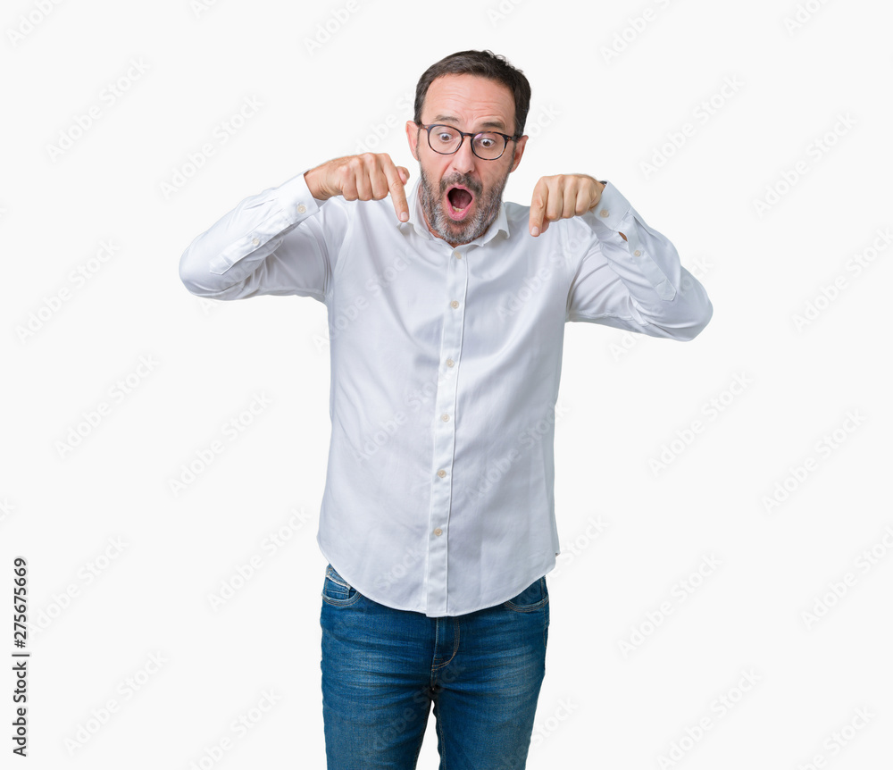 Handsome middle age elegant senior business man wearing glasses over isolated background Pointing down with fingers showing advertisement, surprised face and open mouth Handsome middle age elegant senior business man wearing glasses over isolated background Pointing down with fingers showing advertisement, surprised face and open mouth