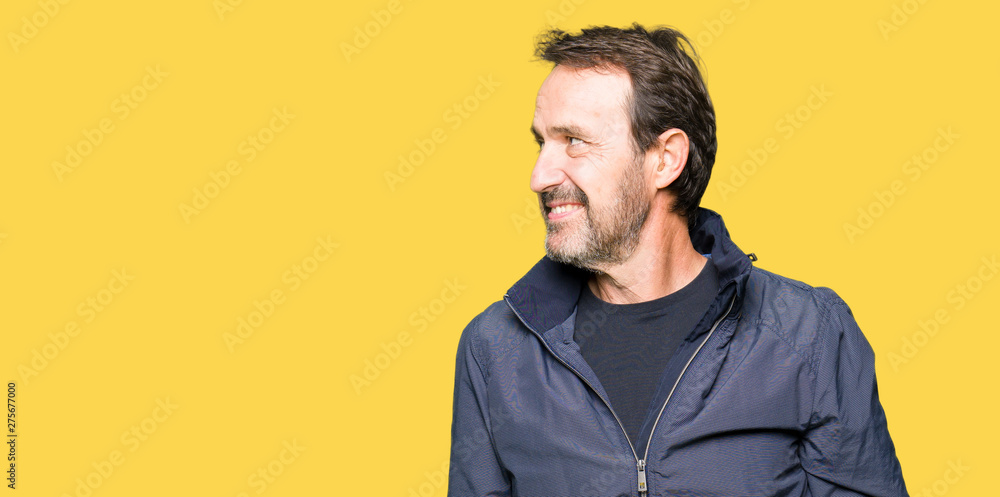 Middle age handsome man wearing a jacket looking away to side with smile on face, natural expression. Laughing confident. Middle age handsome man wearing a jacket looking away to side with smile on face, natural expression. Laughing confident.