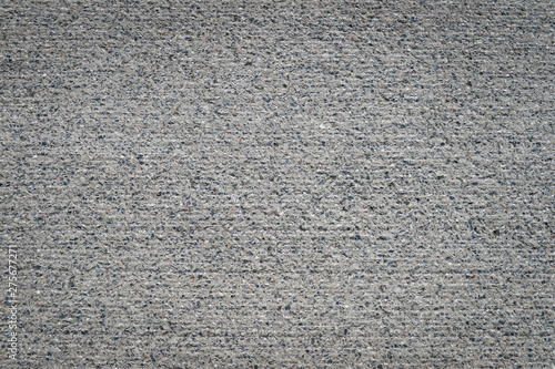 Clean neutral background of rough textured gray concrete wall copy space