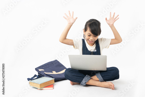 young Asian glad and happy girl student looking on laptop isolated on white background, searching internet and get knowledge concept © khwanchai