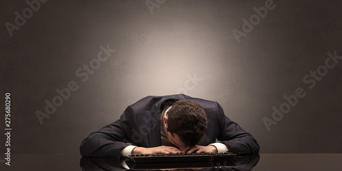 Young businessman fell asleep at his workplace with copy space