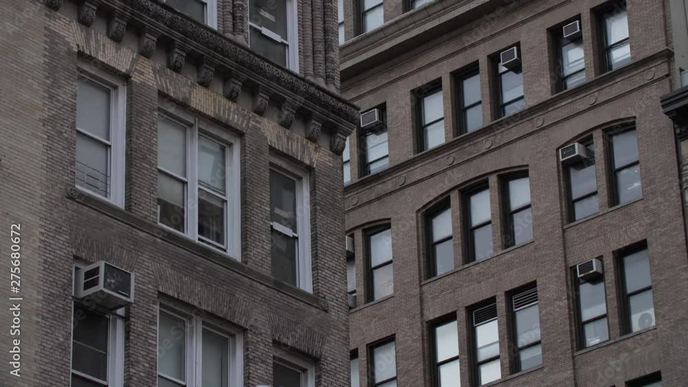 View of a classic New York apartment building with air conditioning units View of a classic New York apartment building with air conditioning units