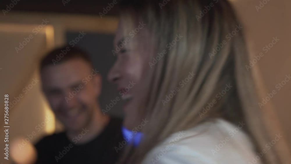 Handsome young guy with his girlfrend having fun on evening playing dancing video games with excellent mood in modern loft club, Handsome young guy with his girlfrend having fun on evening playing dancing video games with excellent mood in modern loft club,