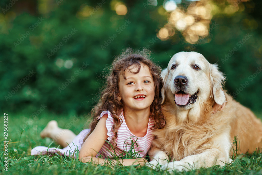 Little girl with a golden retriever, outdoor summer Little girl with a golden retriever, outdoor summer