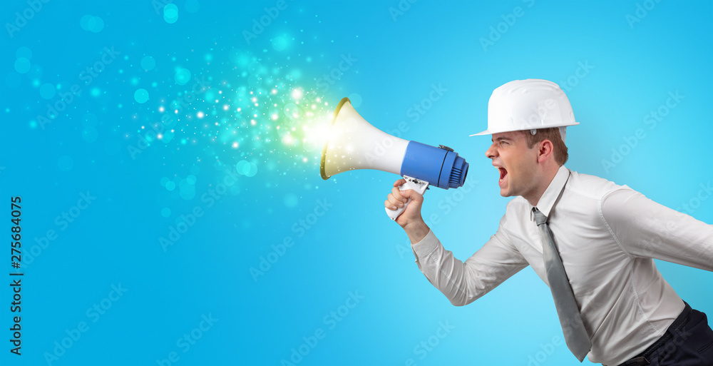 Young architect constructor yelling with megaphone and sparkling sounds
Young architect constructor yelling with megaphone and sparkling sounds