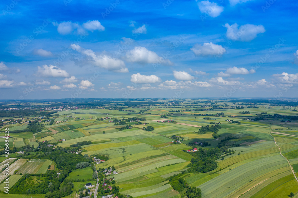 Aerial view of farmlands and mountains in rural Poland seen from drone. Summer time.