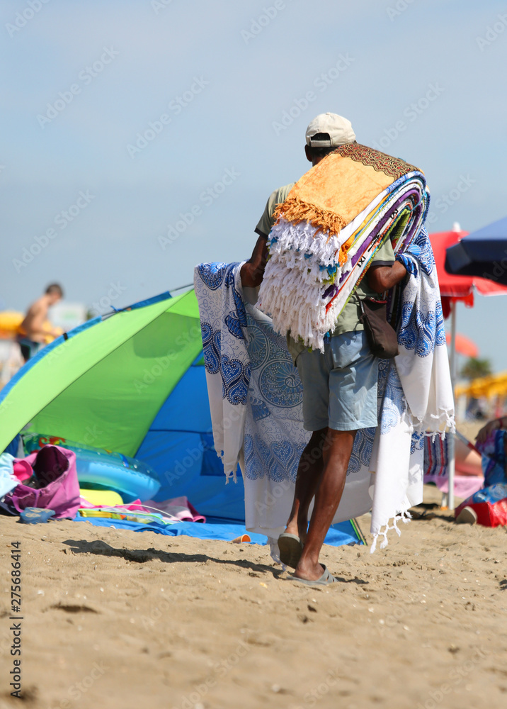abusive itinerant seller on the sand while selling towels and be abusive itinerant seller on the sand while selling towels and be