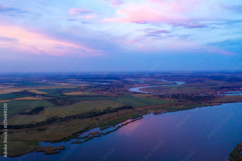 Beautiful sunset in the countryside with a river view shot from the drone