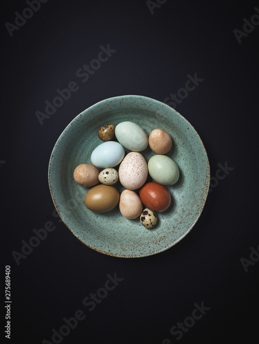 Multicolored Farm Fresh eggs in Ceramic Bowl