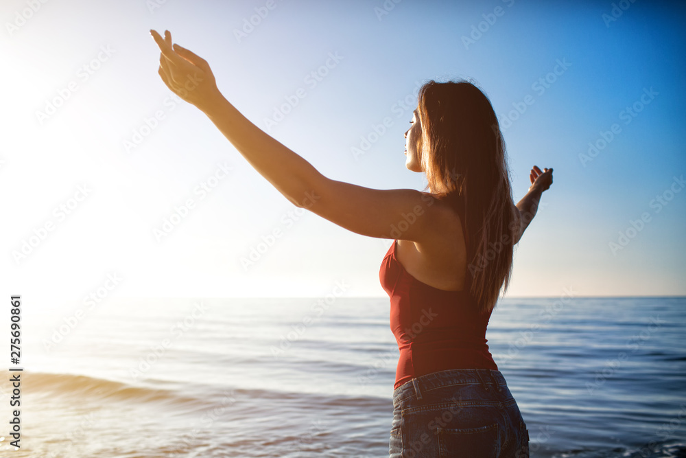 Freedom girl at the beach in a sunny day