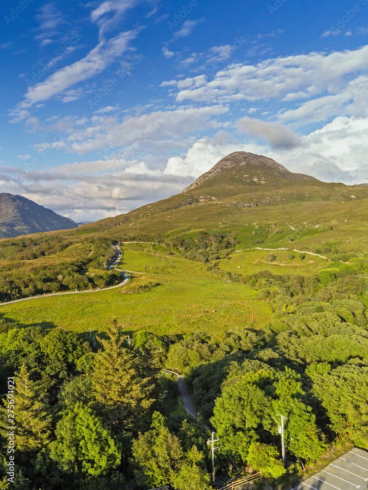 Diamond hill Connemara national park, Ireland, Aerial view, sunny warm day, cloudy sky, Portrait orientation. Diamond hill Connemara national park, Ireland, Aerial view, sunny warm day, cloudy sky, Portrait orientation.