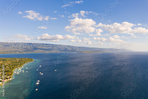 Seascape off the coast of the island of Cebu, Philippines. The blue sea and the big island, view from above.