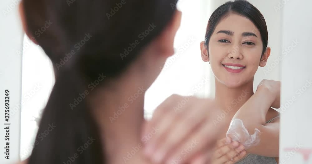 Beautiful woman using lotion with her body with happy emotion. Beauty and Healthcare concept. Beautiful woman using lotion with her body with happy emotion. Beauty and Healthcare concept.