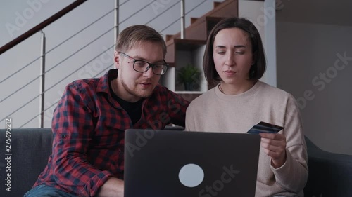 Man and woman using laptop and making online shopping with credi photo