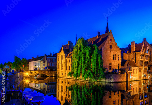 Classic view of the historic city center of Bruges (Brugge), West Flanders province, Belgium. Night cityscape of Bruges. Canals of Brugge