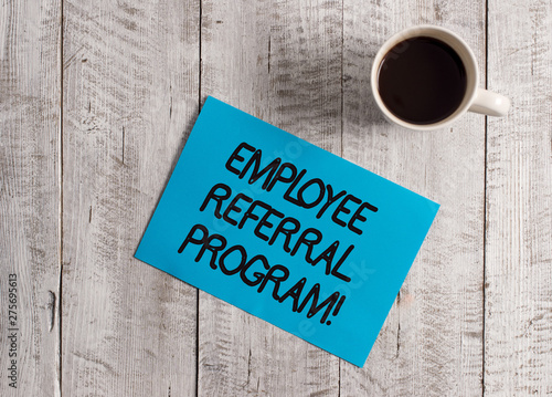 Text sign showing Employee Referral Program. Business photo showcasing internal recruitment method employed by organizations Pastel Colour paper placed next to a cup of coffee above the wooden table