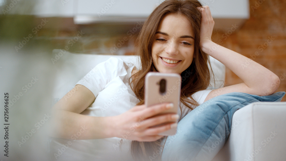 Young woman using smartphone at home.